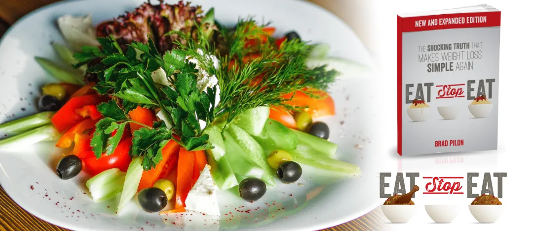 Plate of salad with Eat Stop Eat logo and Book. The original '2 day diet' and intermittent fasting.